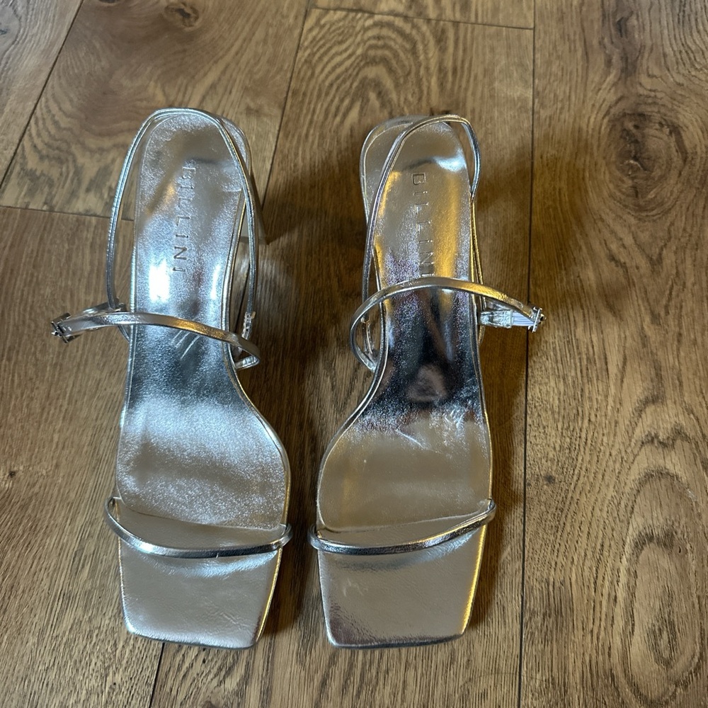 3” heel stiletto with wrap around ankle strap.  Silver metallic